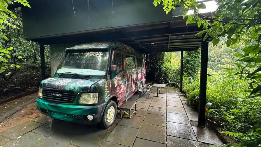Painted caravan van under a jungle canopy shelter at Holistic Eco-Resort