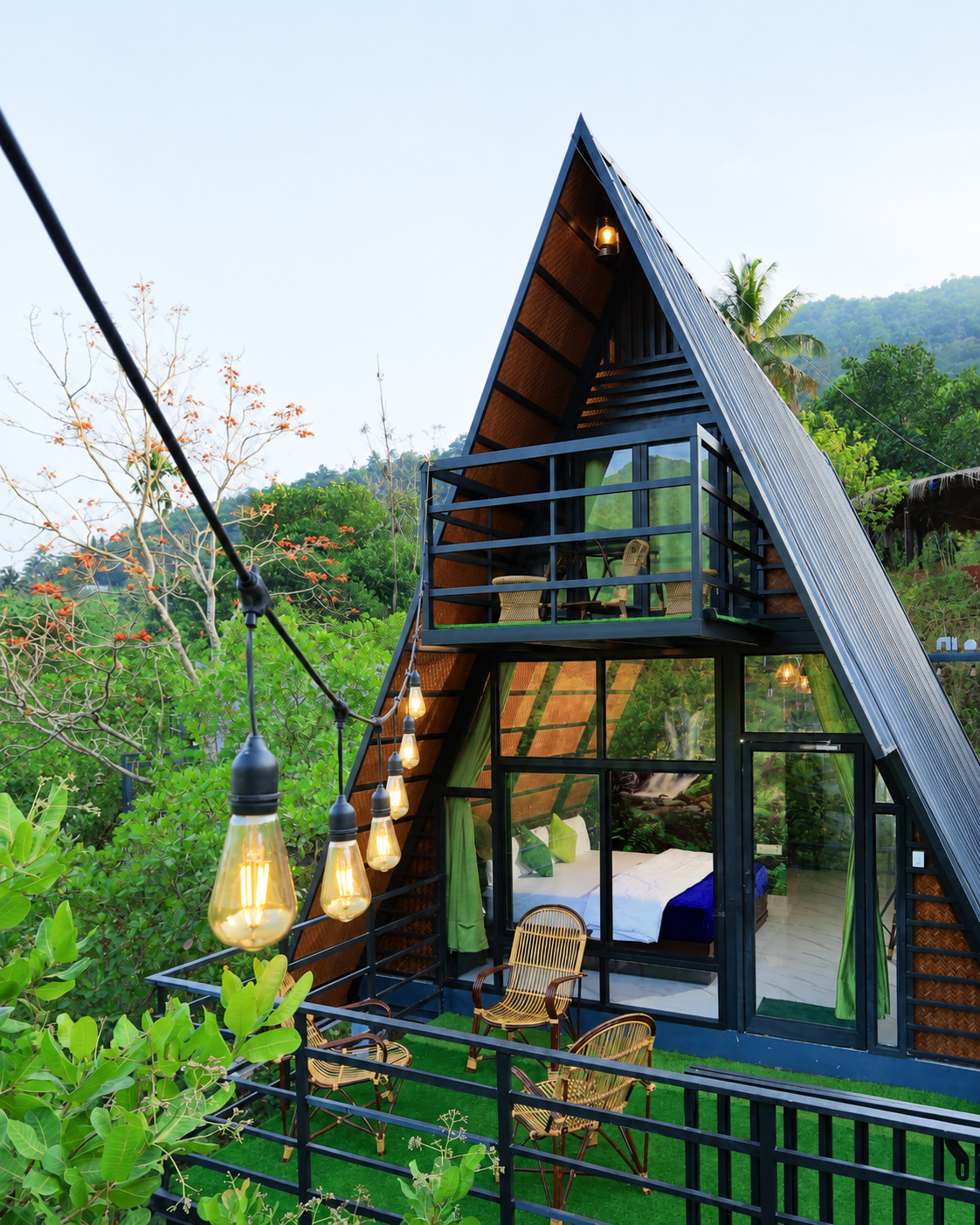 Guitar leaning against glass wall with misty jungle forest view at Holistic Eco-Resort
