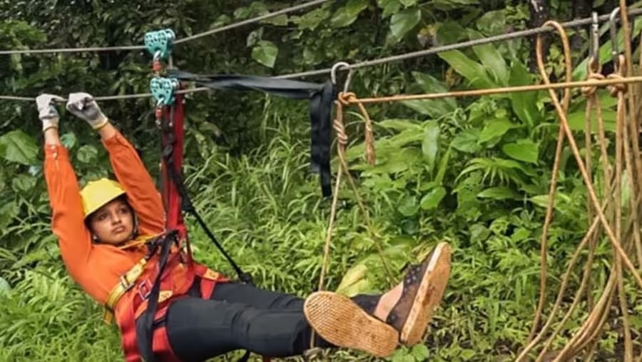 Guest ziplining through the jungle canopy